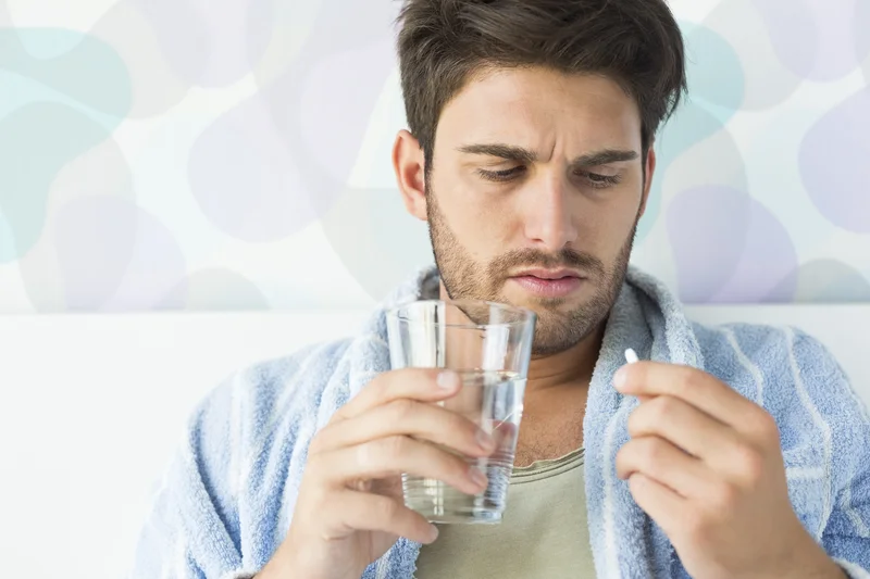 Healthcare professional assisting a patient with medication